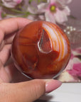 Stunning Banded Carnelian Sphere With Sparkly Druzy Cave